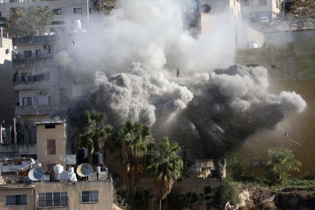 (251202) -- NABLUS, Dec. 2, 2025 (Xinhua) -- Smoke rises as Israeli forces blow up a Palestinian house in the West Bank city of Nablus, Dec. 2, 2025. (Photo by Nidal Eshtayeh/Xinhua)