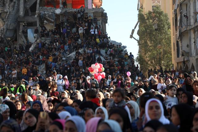 (251202) -- GAZA, Dec. 2, 2025 (Xinhua) -- People watch a Palestinian mass wedding in the southern Gaza Strip city of Khan Younis, Dec. 2, 2025. Fifty-four couples attended the event. (Photo by Rizek Abdeljawad/Xinhua)