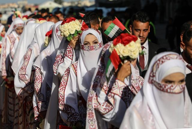 (251202) -- GAZA, Dec. 2, 2025 (Xinhua) -- Palestinian grooms and brides celebrate together a mass wedding in the southern Gaza Strip city of Khan Younis, Dec. 2, 2025. Fifty-four couples attended the event. (Photo by Rizek Abdeljawad/Xinhua)