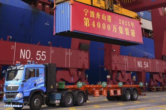 (251203) -- BEIJING, Dec. 3, 2025 (Xinhua) -- This photo taken on Dec. 2, 2025 shows a container being hoisted at the Meishan port area of the Ningbo-Zhoushan Port in east China's Zhejiang Province. A container adorned in red was steadily loaded onto a container ship here on Tuesday, marking the Ningbo-Zhoushan Port's annual container throughput exceeding 40 million TEUs for the first time.
   The Ningbo-Zhoushan Port is the only port in the world that has handled over 1 billion tonnes of cargo annually for 16 consecutive years. (Xinhua/Weng Xinyang)