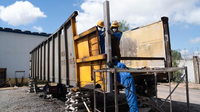(251203) -- Maputo, Dec. 3, 2025 (Xinhua) -- Employees of the China Railway 20th Bureau Group Corporation Limited (CR20) carry out maintenance work on an open wagon in Nacala City, Mozambique, Nov. 24, 2025. TO GO WITH "Feature: Chinese company drives upgrade of Mozambique's Nacala corridor" (Xinhua/Liu Jie)