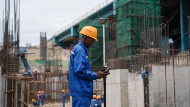 (251203) -- Maputo, Dec. 3, 2025 (Xinhua) -- Orlando Vicente, a surveyor with China Railway 20th Bureau Group Corporation Limited (CR20), conducts measurement work at the construction site of a new rotary car dumper at the coal terminal of the old Nacala Port in Nacala City, Mozambique, Nov. 22, 2025. TO GO WITH "Feature: Chinese company drives upgrade of Mozambique's Nacala corridor" (Xinhua/Liu Jie)