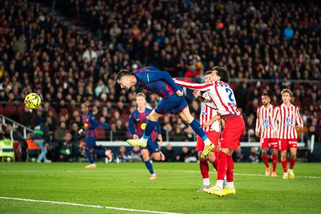 (251203) -- BARCELONA, Dec. 3, 2025 (Xinhua) -- Robert Lewandowski (1st L) of Barcelona heads for the ball during the La Liga football match between FC Barcelona and Atletico de Madrid in Barcelona, Spain, on Dec. 3, 2025. (Photo by Joan Gosa/Xinhua)