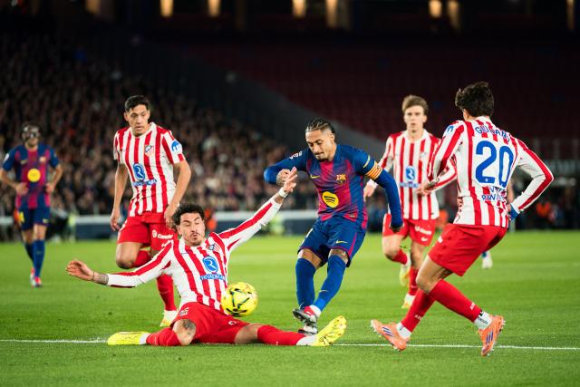 (251203) -- BARCELONA, Dec. 3, 2025 (Xinhua) -- Raphinha (C) of Barcelona kicks the ball during the La Liga football match between FC Barcelona and Atletico de Madrid in Barcelona, Spain, on Dec. 3, 2025. (Photo by Joan Gosa/Xinhua)