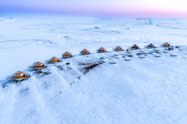 (251203) -- HULUN BUIR, Dec. 3, 2025 (Xinhua) -- An aerial drone photo taken on Dec. 3, 2025 shows yurts on the snow-covered Chenbarhu Banner Grassland in Hulun Buir, north China's Inner Mongolia Autonomous Region. (Xinhua/Ma Jinrui)