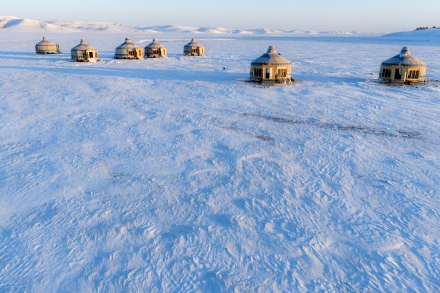 (251203) -- HULUN BUIR, Dec. 3, 2025 (Xinhua) -- An aerial drone photo taken on Dec. 3, 2025 shows yurts on the snow-covered Chenbarhu Banner Grassland in Hulun Buir, north China's Inner Mongolia Autonomous Region. (Xinhua/Darhan)