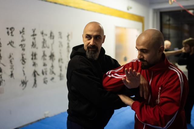 (251203) -- BERLIN, Dec. 3, 2025 (Xinhua) -- Ismet Himmet (L) instructs a student at XUAN-Gong Fu Academy in Berlin, Germany, Nov. 13, 2025.
  Ismet Himmet, with his Chinese name You Lihan, speaks fluent Chinese and has devoted more than thirty years to Chinese martial arts. Himmet, now 48, began learning kung fu in 1991. Nine years later, he traveled to China for the first time. From 2006 he started teaching Chinese martial arts full-time in Germany. At XUAN-Gong Fu Academy, a kung fu school that Himmet established in Berlin, students of all ages practise Tai Chi, Ba Gua Zhang, Xingyiquan and other kung fu styles every day. In his view, martial arts are not just a sport, but also a way of living and something that helps the mind turn toward the positive.
  Thousands of kilometers away, in east China's Shanghai, She Yuran, known as "A Xiao", is engaged in a similar career as Himmet. Born in Sichuan of China, She Yuran studied Historical European Martial Arts (HEMA) at college. His interest in HEMA grew into a deep study of historical weapons and combat methods.
  In 2015, She Yuran co-founded the Shanghai Historical Martial Arts (SHMA) club, offering systematic training in both European and Chinese martial arts. SHMA now has more than 200 members, over half of whom study German swordsmanship. 
  While Ismet Himmet helps Germans understand the philosophy and practice of Chinese martial arts, She Yuran brings European sword traditions to young Chinese practitioners. Their commitment shows how martial arts can carry culture across borders, allowing mutual understanding to grow through their fists and blades. (Xinhua/Zhang Haofu)