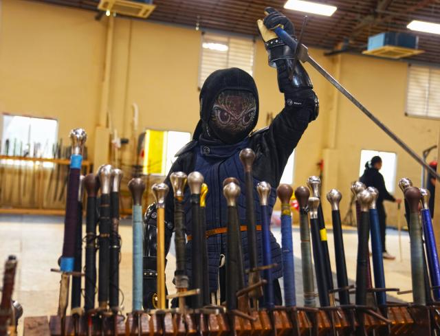 (251203) -- SHANGHAI, Dec. 3, 2025 (Xinhua) -- She Yuran prepares to practice longswords with a friend at the Shanghai Historical Martial Arts (SHMA) club in Shanghai, east China, Nov. 22, 2025. Ismet Himmet, with his Chinese name You Lihan, speaks fluent Chinese and has devoted more than thirty years to Chinese martial arts. Himmet, now 48, began learning kung fu in 1991. Nine years later, he traveled to China for the first time. From 2006 he started teaching Chinese martial arts full-time in Germany. At XUAN-Gong Fu Academy, a kung fu school that Himmet established in Berlin, students of all ages practise Tai Chi, Ba Gua Zhang, Xingyiquan and other kung fu styles every day. In his view, martial arts are not just a sport, but also a way of living and something that helps the mind turn toward the positive.
  Thousands of kilometers away, in east China's Shanghai, She Yuran, known as "A Xiao", is engaged in a similar career as Himmet. Born in Sichuan of China, She Yuran studied Historical European Martial Arts (HEMA) at college. His interest in HEMA grew into a deep study of historical weapons and combat methods.
  In 2015, She Yuran co-founded the Shanghai Historical Martial Arts (SHMA) club, offering systematic training in both European and Chinese martial arts. SHMA now has more than 200 members, over half of whom study German swordsmanship. 
  While Ismet Himmet helps Germans understand the philosophy and practice of Chinese martial arts, She Yuran brings European sword traditions to young Chinese practitioners. Their commitment shows how martial arts can carry culture across borders, allowing mutual understanding to grow through their fists and blades. (Xinhua/Liu Ying)