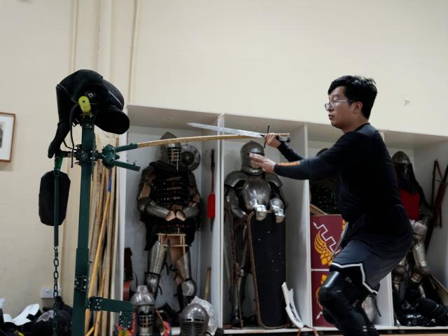 (251203) -- SHANGHAI, Dec. 3, 2025 (Xinhua) -- She Yuran practices on equipment at the Shanghai Historical Martial Arts (SHMA) club in Shanghai, east China, Nov. 22, 2025. Ismet Himmet, with his Chinese name You Lihan, speaks fluent Chinese and has devoted more than thirty years to Chinese martial arts. Himmet, now 48, began learning kung fu in 1991. Nine years later, he traveled to China for the first time. From 2006 he started teaching Chinese martial arts full-time in Germany. At XUAN-Gong Fu Academy, a kung fu school that Himmet established in Berlin, students of all ages practise Tai Chi, Ba Gua Zhang, Xingyiquan and other kung fu styles every day. In his view, martial arts are not just a sport, but also a way of living and something that helps the mind turn toward the positive.
  Thousands of kilometers away, in east China's Shanghai, She Yuran, known as "A Xiao", is engaged in a similar career as Himmet. Born in Sichuan of China, She Yuran studied Historical European Martial Arts (HEMA) at college. His interest in HEMA grew into a deep study of historical weapons and combat methods.
  In 2015, She Yuran co-founded the Shanghai Historical Martial Arts (SHMA) club, offering systematic training in both European and Chinese martial arts. SHMA now has more than 200 members, over half of whom study German swordsmanship. 
  While Ismet Himmet helps Germans understand the philosophy and practice of Chinese martial arts, She Yuran brings European sword traditions to young Chinese practitioners. Their commitment shows how martial arts can carry culture across borders, allowing mutual understanding to grow through their fists and blades. (Xinhua/Liu Ying)