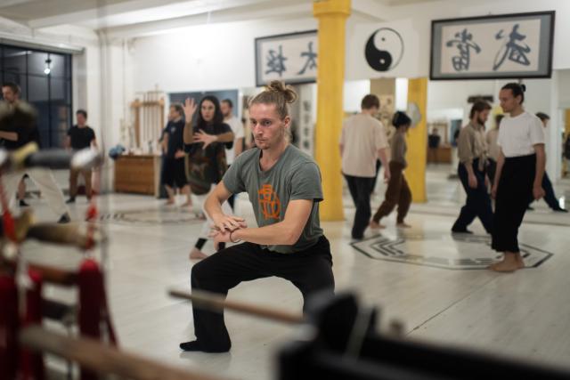 (251203) -- BERLIN, Dec. 3, 2025 (Xinhua) -- This photo shows the reflected mirror image of students practicing at XUAN-Gong Fu Academy in Berlin, Germany, Nov. 13, 2025. Ismet Himmet, with his Chinese name You Lihan, speaks fluent Chinese and has devoted more than thirty years to Chinese martial arts. Himmet, now 48, began learning kung fu in 1991. Nine years later, he traveled to China for the first time. From 2006 he started teaching Chinese martial arts full-time in Germany. At XUAN-Gong Fu Academy, a kung fu school that Himmet established in Berlin, students of all ages practise Tai Chi, Ba Gua Zhang, Xingyiquan and other kung fu styles every day. In his view, martial arts are not just a sport, but also a way of living and something that helps the mind turn toward the positive.
  Thousands of kilometers away, in east China's Shanghai, She Yuran, known as "A Xiao", is engaged in a similar career as Himmet. Born in Sichuan of China, She Yuran studied Historical European Martial Arts (HEMA) at college. His interest in HEMA grew into a deep study of historical weapons and combat methods.
  In 2015, She Yuran co-founded the Shanghai Historical Martial Arts (SHMA) club, offering systematic training in both European and Chinese martial arts. SHMA now has more than 200 members, over half of whom study German swordsmanship. 
  While Ismet Himmet helps Germans understand the philosophy and practice of Chinese martial arts, She Yuran brings European sword traditions to young Chinese practitioners. Their commitment shows how martial arts can carry culture across borders, allowing mutual understanding to grow through their fists and blades. (Xinhua/Zhang Haofu)