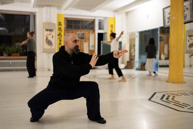 (251203) -- BERLIN, Dec. 3, 2025 (Xinhua) -- Ismet Himmet demonstrates Chinese martial arts at XUAN-Gong Fu Academy in Berlin, Germany, Nov. 13, 2025. Ismet Himmet, with his Chinese name You Lihan, speaks fluent Chinese and has devoted more than thirty years to Chinese martial arts. Himmet, now 48, began learning kung fu in 1991. Nine years later, he traveled to China for the first time. From 2006 he started teaching Chinese martial arts full-time in Germany. At XUAN-Gong Fu Academy, a kung fu school that Himmet established in Berlin, students of all ages practise Tai Chi, Ba Gua Zhang, Xingyiquan and other kung fu styles every day. In his view, martial arts are not just a sport, but also a way of living and something that helps the mind turn toward the positive.
  Thousands of kilometers away, in east China's Shanghai, She Yuran, known as "A Xiao", is engaged in a similar career as Himmet. Born in Sichuan of China, She Yuran studied Historical European Martial Arts (HEMA) at college. His interest in HEMA grew into a deep study of historical weapons and combat methods.
  In 2015, She Yuran co-founded the Shanghai Historical Martial Arts (SHMA) club, offering systematic training in both European and Chinese martial arts. SHMA now has more than 200 members, over half of whom study German swordsmanship. 
  While Ismet Himmet helps Germans understand the philosophy and practice of Chinese martial arts, She Yuran brings European sword traditions to young Chinese practitioners. Their commitment shows how martial arts can carry culture across borders, allowing mutual understanding to grow through their fists and blades. (Xinhua/Zhang Haofu)