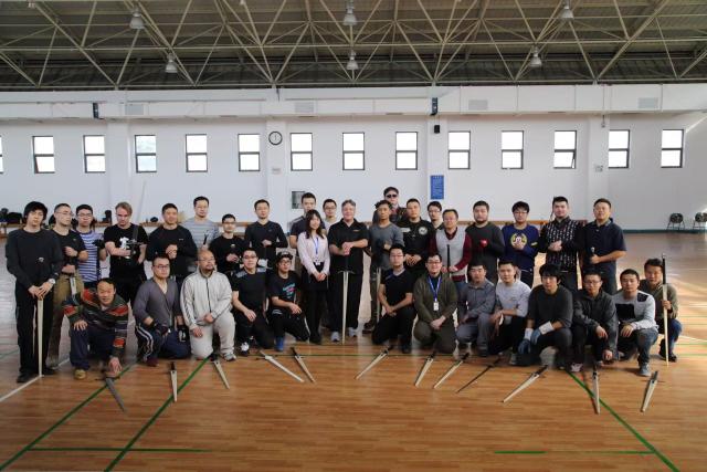 (251203) -- SHANGHAI, Dec. 3, 2025 (Xinhua) -- This undated file photo shows members of the Shanghai Historical Martial Arts (SHMA) club and a German teacher posing for a group photo after class in Shanghai, east China. Ismet Himmet, with his Chinese name You Lihan, speaks fluent Chinese and has devoted more than thirty years to Chinese martial arts. Himmet, now 48, began learning kung fu in 1991. Nine years later, he traveled to China for the first time. From 2006 he started teaching Chinese martial arts full-time in Germany. At XUAN-Gong Fu Academy, a kung fu school that Himmet established in Berlin, students of all ages practise Tai Chi, Ba Gua Zhang, Xingyiquan and other kung fu styles every day. In his view, martial arts are not just a sport, but also a way of living and something that helps the mind turn toward the positive.
  Thousands of kilometers away, in east China's Shanghai, She Yuran, known as "A Xiao", is engaged in a similar career as Himmet. Born in Sichuan of China, She Yuran studied Historical European Martial Arts (HEMA) at college. His interest in HEMA grew into a deep study of historical weapons and combat methods.
  In 2015, She Yuran co-founded the Shanghai Historical Martial Arts (SHMA) club, offering systematic training in both European and Chinese martial arts. SHMA now has more than 200 members, over half of whom study German swordsmanship. 
  While Ismet Himmet helps Germans understand the philosophy and practice of Chinese martial arts, She Yuran brings European sword traditions to young Chinese practitioners. Their commitment shows how martial arts can carry culture across borders, allowing mutual understanding to grow through their fists and blades. (Xinhua)