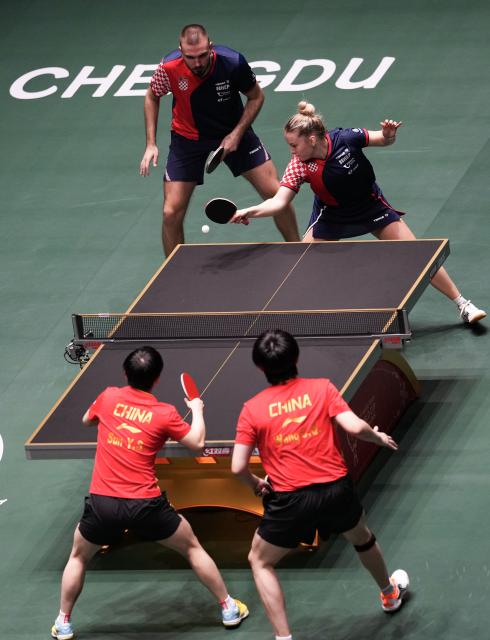 (251203) -- CHENGDU, Dec. 3, 2025 (Xinhua) -- Ivor Ban(top L)/Hana Arapovic(top R) of Croatia compete during the mixed doubles match against Wang Chuqin(bottom R)/Sun Yingsha of China during the stage 2 match between China and Croatia at the ITTF Mixed Team World Cup 2025 in Chengdu, southwest China's Sichuan Province, Dec. 3, 2025. (Xinhua/Wang Ying)