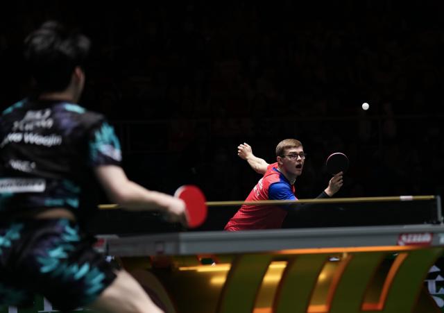 (251203) -- CHENGDU, Dec. 3, 2025 (Xinhua) -- Alexis Lebrun (R) of France competes in the men's singles match against Jang Woojin of South Korea during the stage 2 group match between South Korea and France at the ITTF Mixed Team World Cup 2025 in Chengdu, southwest China's Sichuan Province, Dec. 3, 2025. (Xinhua/Wang Ying)