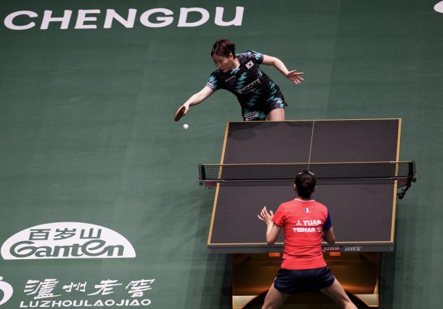 (251203) -- CHENGDU, Dec. 3, 2025 (Xinhua) -- Lee Eunhye (top) of South Korea hits a return in the women's singles match against Yuan Jia Nan of France during the stage 2 group match between South Korea and France at the ITTF Mixed Team World Cup 2025 in Chengdu, southwest China's Sichuan Province, Dec. 3, 2025. (Xinhua/Wang Ying)