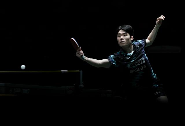 (251203) -- CHENGDU, Dec. 3, 2025 (Xinhua) -- Jang Woojin (front) of South Korea hits a return in the men's singles match against Alexis Lebrun of France during the stage 2 group match between South Korea and France at the ITTF Mixed Team World Cup 2025 in Chengdu, southwest China's Sichuan Province, Dec. 3, 2025. (Xinhua/Wang Ying)