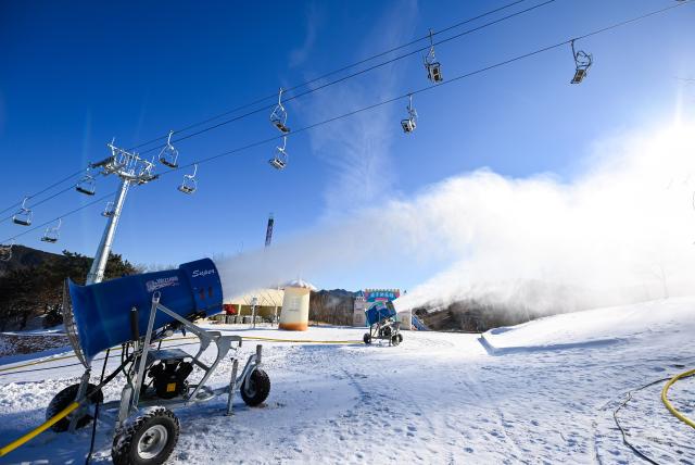 (251203) -- TIANJIN, Dec. 3, 2025 (Xinhua) -- Machines generate and spray artificial snow at a ski resort in Jizhou District, north China's Tianjin, Dec. 2, 2025. In recent years, authorities in Jizhou District of Tianjin, which sits on the east section of the Yanshan Mountain, have been boosting ice and snow tourism by exploring local resources and improving service infrastructure. (Xinhua/Zhao Zishuo)