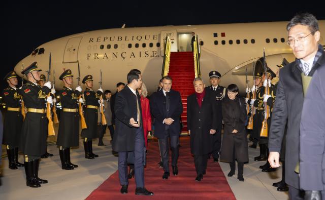 (251203) -- BEIJING, Dec. 3, 2025 (Xinhua) -- French President Emmanuel Macron is welcomed by Chinese Foreign Minister Wang Yi, also a member of the Political Bureau of the Communist Party of China (CPC) Central Committee, upon his arrival in Beijing, capital of China, Dec. 3, 2025. At the invitation of Chinese President Xi Jinping, Macron arrived here on Wednesday for a state visit to China through Friday. (Xinhua/Cai Yang)