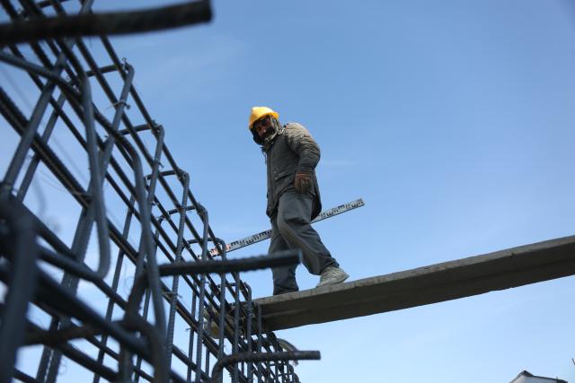 (251203) -- KABUL, Dec. 3, 2025 (Xinhua) -- A man works at a construction site in Kabul, Afghanistan, on Dec. 3, 2025. The Afghan government's national procurement commission has approved 11 development projects valued at 1.5 billion afghani (over 22.5 million U.S. dollars) to boost infrastructure, healthcare, and economic opportunities, the office of the deputy prime minister for economic affairs announced Tuesday. (Photo by Saifurahman Safi/Xinhua)