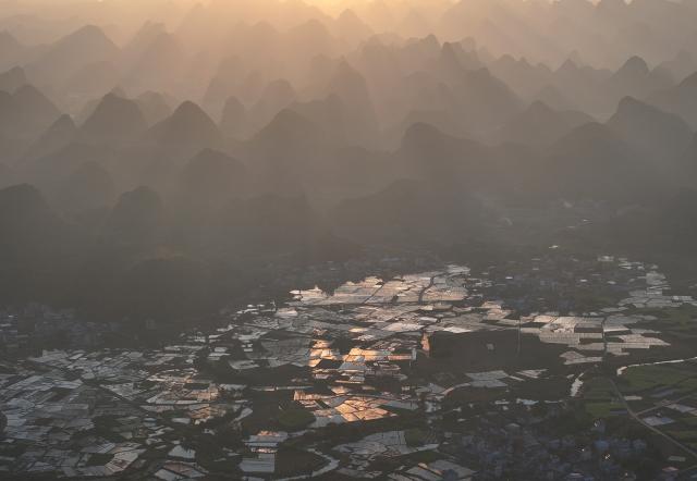 (251203) -- LIUZHOU, Dec. 3, 2025 (Xinhua) -- This aerial drone photo taken on Nov. 23, 2025 shows a view of Baipeng Village, Liujiang District, Liuzhou City, south China's Guangxi Zhuang Autonomous Region. In recent years, Liujiang District of Liuzhou City has leveraged its thriving rural industries and vibrant agricultural economy to expand its tourism business. In the first three quarters of this year, Liujiang District received a total of 5.9975 million visits, a year-on-year increase of 11.16 percent, with tourism-related revenue of 6.006 billion yuan (850.26 million U.S. dollars), up 9.91 percent compared to the same period last year. (Xinhua/Huang Xiaobang)