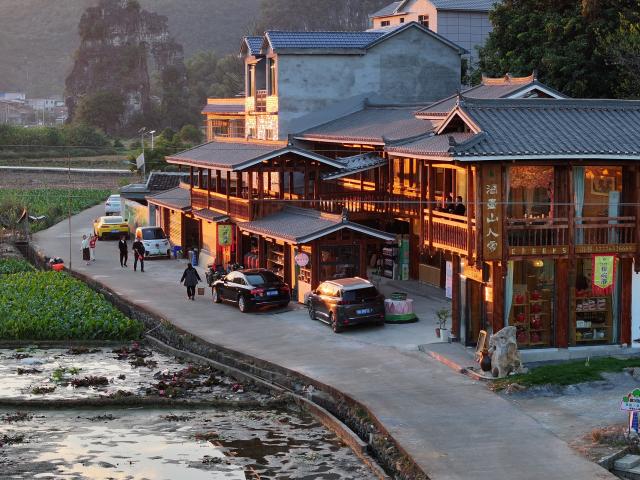(251203) -- LIUZHOU, Dec. 3, 2025 (Xinhua) -- This aerial drone photo taken on Nov. 23, 2025 shows tourists visiting Baipeng village in Liujiang District, Liuzhou City, south China's Guangxi Zhuang Autonomous Region. In recent years, Liujiang District of Liuzhou City has leveraged its thriving rural industries and vibrant agricultural economy to expand its tourism business. In the first three quarters of this year, Liujiang District received a total of 5.9975 million visits, a year-on-year increase of 11.16 percent, with tourism-related revenue of 6.006 billion yuan (850.26 million U.S. dollars), up 9.91 percent compared to the same period last year. (Xinhua/Huang Xiaobang)