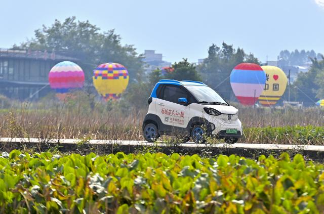 (251203) -- LIUZHOU, Dec. 3, 2025 (Xinhua) -- Tourists visit Baipeng village in Liujiang District, Liuzhou City, south China's Guangxi Zhuang Autonomous Region, Dec. 2, 2025. In recent years, Liujiang District of Liuzhou City has leveraged its thriving rural industries and vibrant agricultural economy to expand its tourism business. In the first three quarters of this year, Liujiang District received a total of 5.9975 million visits, a year-on-year increase of 11.16 percent, with tourism-related revenue of 6.006 billion yuan (850.26 million U.S. dollars), up 9.91 percent compared to the same period last year. (Xinhua/Huang Xiaobang)
