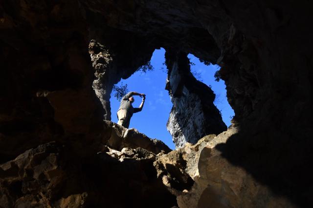 (251203) -- LIUZHOU, Dec. 3, 2025 (Xinhua) -- A tourist takes photos at Jiuhu Mountain, Baipeng Village, Liujiang District, Liuzhou City, south China's Guangxi Zhuang Autonomous Region, Nov. 23, 2025. In recent years, Liujiang District of Liuzhou City has leveraged its thriving rural industries and vibrant agricultural economy to expand its tourism business. In the first three quarters of this year, Liujiang District received a total of 5.9975 million visits, a year-on-year increase of 11.16 percent, with tourism-related revenue of 6.006 billion yuan (850.26 million U.S. dollars), up 9.91 percent compared to the same period last year. (Xinhua/Huang Xiaobang)