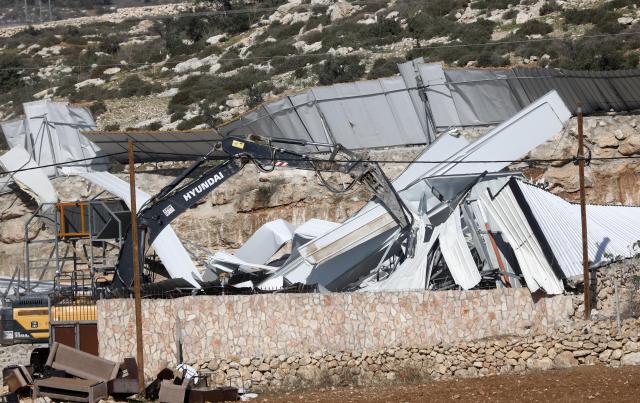 (251203) -- HEBRON, Dec. 3, 2025 (Xinhua) -- Israeli military bulldozer demolishes a facility in Beit Oula town northwest of Hebron in the West Bank, on Dec. 3, 2025. (Photo by Mamoun Wazwaz/Xinhua)
