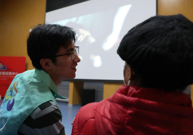 (251204) -- SHENYANG, Dec. 4, 2025 (Xinhua) -- A volunteer (L) whispers with a visually-impaired person at a cinema in Hunnan District of Shenyang, northeast China's Liaoning Province, Dec. 3, 2025. Visually-impaired people enjoyed the barrier-free version of movie "Born to Fly" and movie "Island Keeper" respectively in Yingkou City and Shenyang City of Liaoning lately on the occasion of the 34th International Day of Persons with Disabilities, which fell on Wednesday this year. The movie screening activity was under the Cinema of Light, a public welfare initiative initiated in 2017 by the Communication University of China. 
    The initiative aims to produce duplicable and distributable films with voice descriptions inserted during pauses in dialogue and sound effects, providing explanations of the visual content, emotions and meanings behind the scenes. (Xinhua/Li Gang)