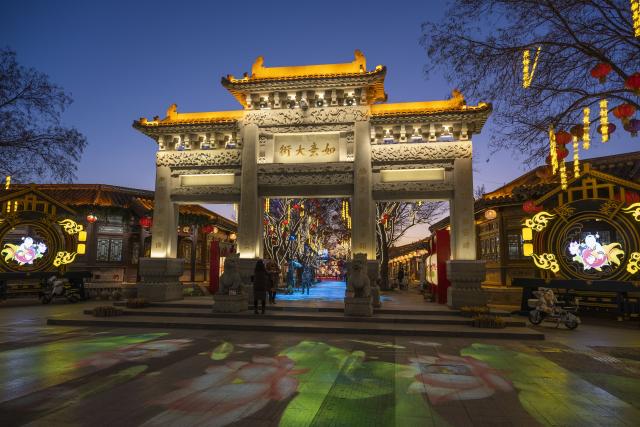 (251204) -- TIANJIN, Dec. 4, 2025 (Xinhua) -- Tourists enjoy themselves at Yangliuqing ancient town in Tianjin, north China, on Dec. 3, 2025. Sitting on the outskirts of the port city of Tianjin, Yangliuqing ancient town is a tourist town that is well-known for its woodblock new year pictures. It is run through by the Grand Canal, the world's longest man-made waterway. (Xinhua/Fu Tian)