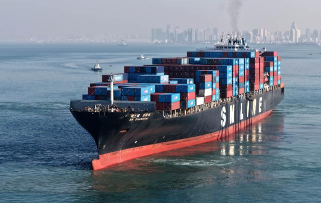 (251204) -- QINGDAO, Dec. 4, 2025 (Xinhua) -- A drone photo taken on Dec. 4, 2025 shows a cargo ship loaded with containers departing from the Qianwan Container Terminal of Qingdao Port in east China's Shandong Province. With nearly 240 foreign trade routes, Qingdao Port connects over 700 ports in more than 180 countries and regions worldwide. (Xinhua/Li Ziheng)