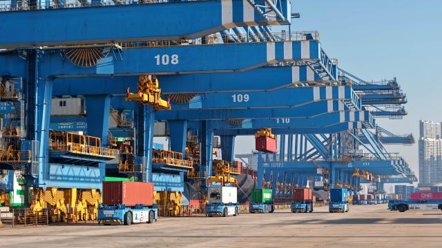 (251204) -- QINGDAO, Dec. 4, 2025 (Xinhua) -- A drone photo taken on Dec. 4, 2025 shows automated guided vehicles transporting containers at a fully automated container terminal of Qingdao Port, east China's Shandong Province. With nearly 240 foreign trade routes, Qingdao Port connects over 700 ports in more than 180 countries and regions worldwide. (Xinhua/Li Ziheng)