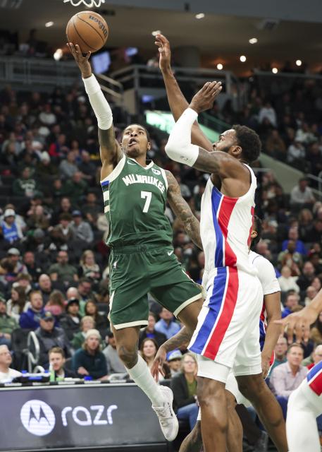 (251204) -- MILWAUKEE, Dec. 4, 2025 (Xinhua) -- Kevin Porter Jr. (L) of Milwaukee Bucks goes for a layup during the 2025-2026 NBA regular season game between Milwaukee Bucks and Detroit Pistons in Milwaukee, the United States, on Dec. 3, 2025. (Photo by Joel Lerner/Xinhua)
