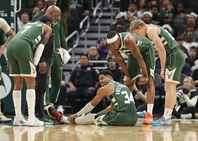 (251204) -- MILWAUKEE, Dec. 4, 2025 (Xinhua) -- Thanasis Antetokounmpo (C) of Milwaukee Bucks sits on the ground after getting injured during the 2025-2026 NBA regular season game between Milwaukee Bucks and Detroit Pistons in Milwaukee, the United States, on Dec. 3, 2025. (Photo by Joel Lerner/Xinhua)