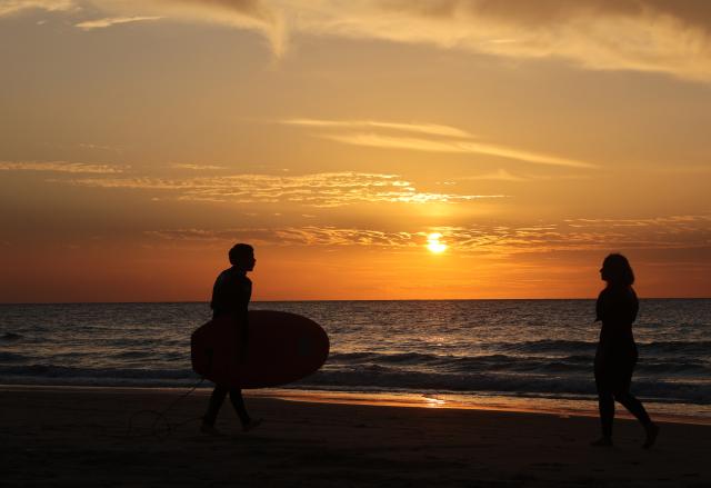 (251204) -- HAIFA, Dec. 4, 2025 (Xinhua) -- People enjoy leisure time on the beach in Haifa, northern Israel, Dec. 3, 2025. (Photo by Gil Cohen Magen/Xinhua)