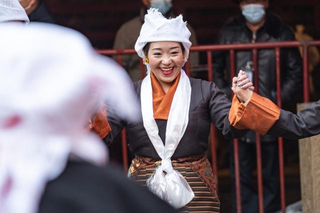 (251204) -- LHASA, Dec. 4, 2025 (Xinhua) -- People dance Guozhuang, a traditional Tibetan square dance, at Jokhang Temple in Lhasa, southwest China's Xizang Autonomous Region, Dec. 4, 2025. Xizang marked the annual Fairy's Day, also known as the "Women's Festival", on Thursday, the 15th day of the tenth month in the Tibetan calendar. Women in festive attire were seen on the streets carrying hada scarves and barley wine as they headed to Jokhang Temple to pay homage to Palden Lhamo, a goddess in Tibetan Buddhism. (Xinhua/Tenzin Nyida)