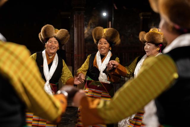 (251204) -- LHASA, Dec. 4, 2025 (Xinhua) -- People dance Guozhuang, a traditional Tibetan square dance, at Jokhang Temple in Lhasa, southwest China's Xizang Autonomous Region, Dec. 4, 2025. Xizang marked the annual Fairy's Day, also known as the "Women's Festival", on Thursday, the 15th day of the tenth month in the Tibetan calendar. Women in festive attire were seen on the streets carrying hada scarves and barley wine as they headed to Jokhang Temple to pay homage to Palden Lhamo, a goddess in Tibetan Buddhism. (Xinhua/Tenzing Nima Qadhup)