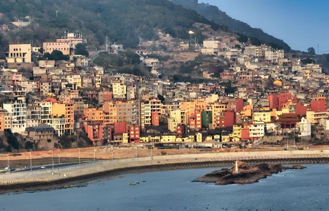 (251204) -- XIAPU, Dec. 4, 2025 (Xinhua) -- An aerial drone photo shows guesthouses along the coastal road for sightseeing in Sansha Town, Xiapu County, southeast China's Fujian Province, Dec. 3, 2025. Sansha Town in Xiapu County, blessed with unique natural resources and rich historical culture, has been walking a distinctive path to rural revitalization by orchestrating tourist attractions such as high-end homestays, tidal flat landscape and local specialty food with rural development. (Xinhua/Wei Peiquan)