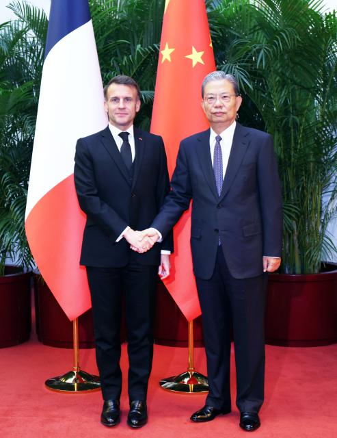 (251204) -- BEIJING, Dec. 4, 2025 (Xinhua) -- Zhao Leji, chairman of the National People's Congress Standing Committee, meets with French President Emmanuel Macron in Beijing, capital of China, Dec. 4, 2025. (Xinhua/Liu Weibing)