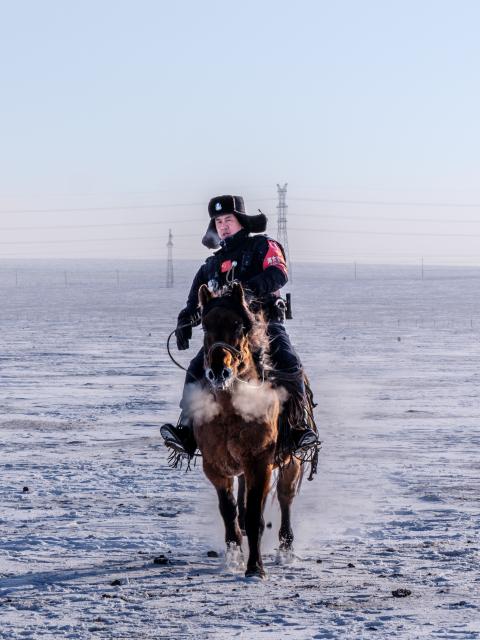 (251204) -- HULUN BUIR, Dec. 4, 2025 (Xinhua) -- A policeman of the "Gyrfalcon" mounted police team conducts training activities on snow-covered Chenbarhu Banner Grassland in Hulun Buir, north China's Inner Mongolia Autonomous Region, Dec. 2, 2025.
  Deep in the snow-shrouded grassland in Chenbarhu Banner, a row of mounted police patrol on horseback, grappling with gusts and snow. They carry out security guard patrols and management on the vast grassland across an area of 18,600 square kilometers. Equipped with well-trained horses, each of which has undergone more than six months of systematic training, the police team stands as a "symbol of safety" on the grassland, safeguarding local herdsmen all year round.
  The "Gyrfalcon" mounted police team, which was founded in 2015, is the first of its kind in Hulun Buir. Over the past decade, police officers of the team have been dedicating themselves to working under harsh conditions in the northern borderland of China. Whether braving intense ultraviolet rays in summer or carrying out special training on the snowfields with temperatures reaching minus 40 degrees Celsius in winter, the team has never hesitated to perform its duties.
  Apart from routine patrols and training, the team has also contributed to the safety of local schools, directing the traffic and escorting pupils through snow-covered streets.
  To date, the team's total patrol mileage has exceeded 140,000 kilometers and it has helped nearly 700 residents out of danger. From the grasslands to nearby towns, the "Gyrfalcon" mounted police team is the loyal guardian of local people and land. (Xinhua/Ma Jinrui)
