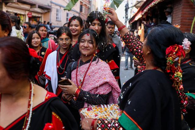 (251204) -- KATHMANDU, Dec. 4, 2025 (Xinhua) -- People in traditional attire take part in a rally celebrating Yomari Punhi in Kathmandu, Nepal, on Dec. 4, 2025. Yomari Punhi is a festival especially celebrated by Newar community in Nepal to mark the end of the rice harvest on full moon day. (Photo by Sulav Shrestha/Xinhua)