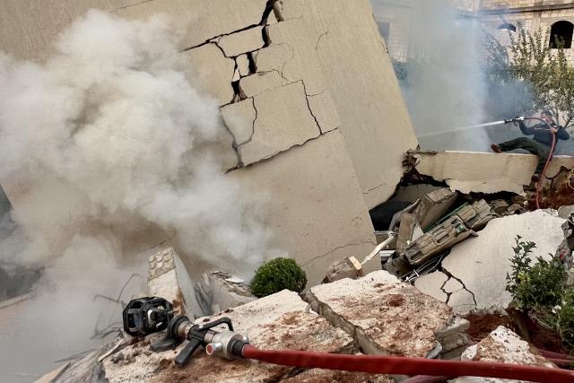(251204) -- JBAA, Dec. 4, 2025 (Xinhua) -- A firefighter attempts to extinguish fire in a building destroyed by Israeli airstrikes in the town of Jbaa, south Lebanon, Dec. 4, 2025. Israeli airstrikes targeted buildings in four towns in southern Lebanon on Thursday afternoon, Lebanon's official National News Agency reported. According to a Lebanese army intelligence source, four buildings were destroyed and around 20 nearby homes were damaged. (Photo by Ali Hashisho/Xinhua)