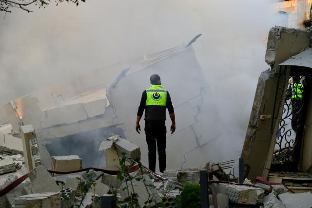 (251204) -- JBAA, Dec. 4, 2025 (Xinhua) -- A rescue worker inspects buildings destroyed by Israeli airstrikes in the town of Jbaa, south Lebanon, Dec. 4, 2025. Israeli airstrikes targeted buildings in four towns in southern Lebanon on Thursday afternoon, Lebanon's official National News Agency reported. According to a Lebanese army intelligence source, four buildings were destroyed and around 20 nearby homes were damaged. (Photo by Ali Hashisho/Xinhua)