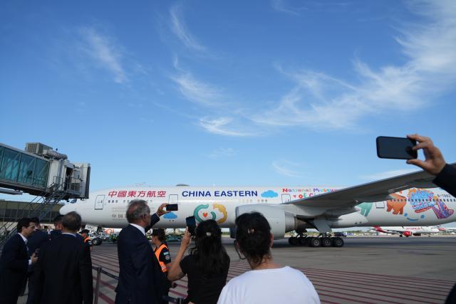 (251205) -- BUENOS AIRES, Dec. 5, 2025 (Xinhua) -- Staff welcome China Eastern Airlines' flight MU745, the first direct air route between China and Argentina, at Ezeiza International Airport in Buenos Aires, Argentina, Dec. 4, 2025. China Eastern Airlines' flight MU745 touched down in Buenos Aires, the capital of Argentina, on Thursday afternoon, marking the official launch of the first direct air route between China and Argentina, according to the carrier. (Xinhua/Zhang Duo)
