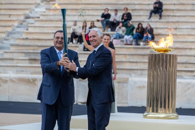 (251205) -- BEIJING, Dec. 5, 2025 (Xinhua) -- President of the organizing committee for the 2026 Winter Olympics Giovanni Malago (R) and president of the Hellenic Olympic Committee Isidoros Kouvelos are seen during the Olympic flame handover ceremony for the Milan-Cortina 2026 Winter Olympic Games at Panathenaic stadium in Athens, Greece, Dec. 4, 2025. (Photo by Marios Lolos/Xinhua)