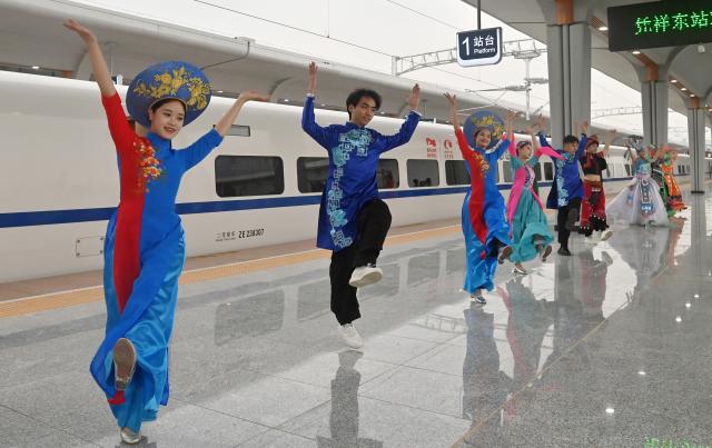 (251205) -- NANNING, Dec. 5, 2025 (Xinhua) -- People perform a dance in celebration of the full operation of the Nanning-Pingxiang Railway at Pingxiang East Railway Station, in Pingxiang City, south China's Guangxi Zhuang Autonomous Region, on Dec. 5, 2025. The Chongzuo-Pingxiang section of the Nanning-Pingxiang Railway began operation on Friday, marking the full operation of the high-speed railway, which connects the region's capital city Nanning to the border city Pingxiang. (Xinhua/Lu Boan)