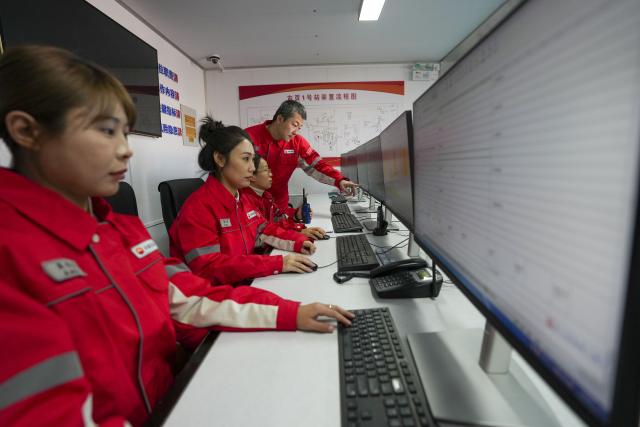 (251205) -- DAQING, Dec. 5, 2025 (Xinhua) -- Technicians check the operating parameters of the oil and gas processing equipment at a national-level demonstration zone of continental shale oil of Daqing Oilfield in Daqing, northeast China's Heilongjiang Province, Dec. 4, 2025. Daqing Oilfield, one of China's largest energy production bases, announced Friday that the yearly output of the shale oil in the demonstration zone has exceeded one million tonnes. (Xinhua/Wang Song)