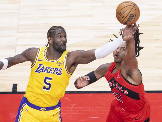 (251205) -- TORONTO, Dec. 5, 2025 (Xinhua) -- Collin Murray-Boyles (R) of Toronto Raptors fights for a rebound with Deandre Ayton of Los Angeles Lakers during the 2025-2026 NBA regular season game between Toronto Raptors and Los Angeles Lakers in Toronto, Canada, on Dec. 4, 2025. (Photo by Zou Zheng/Xinhua)