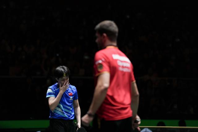 (251205) -- CHENGDU, Dec. 5, 2025 (Xinhua) -- Wang Chuqin (L) of China reacts in the men's singles match against Patrick Franziska of Germany during the stage 2 group match between China and Germany at the ITTF Mixed Team World Cup 2025 in Chengdu, southwest China's Sichuan Province, Dec. 5, 2025. (Xinhua/Wang Ying)