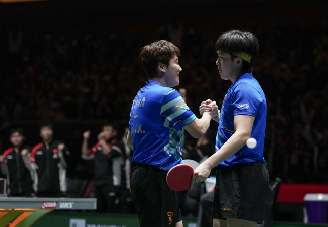 (251205) -- CHENGDU, Dec. 5, 2025 (Xinhua) -- Wang Chuqin (R)/Liang Jingkun of China celebrate after winning the men's doubles match against Benedikt Duda/Qiu Dang of Germany during the stage 2 group match between China and Germany at the ITTF Mixed Team World Cup 2025 in Chengdu, southwest China's Sichuan Province, Dec. 5, 2025. (Xinhua/Wang Ying)